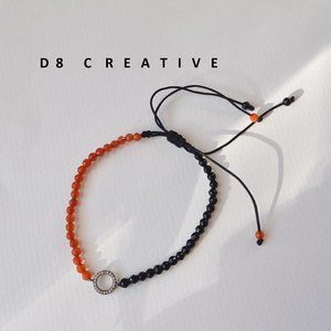 Hand woven orange agate with black agate and sterling silver pendant bracelet